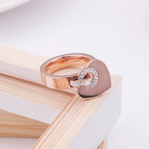 Fashionable 18k gold plated heart ring with sparkling rhinestone detail on a wooden frame