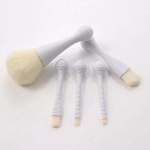 Detailed view of 5 lollipop makeup brushes with white rippled handles and beige bristles