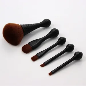 Detail of 5-piece makeup brush set with brown synthetic bristles and non-slip handles
