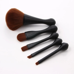 Close-up of 5-piece makeup brush set with black spiral handles and soft brown bristles