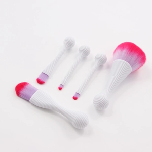 Detail of 5 makeup brushes with white spiral ball handles and purple pink gradient bristles