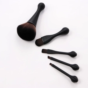 Detail of 5-piece portable makeup brush set with black handles and soft synthetic bristles