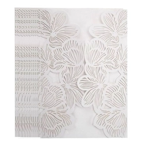 Detailed view of intricate laser-cut white floral patterns on wedding invitation cards