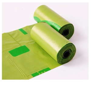 Close-up of biodegradable green dog waste bags showing roll texture and thickness