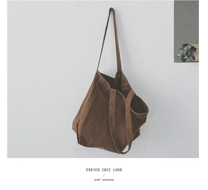 Brown minimalist canvas tote bag hanging on a white wall with French Chic Look text
