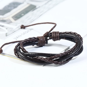 Detail of dark brown braided leather multilayer bracelet with adjustable cord closure