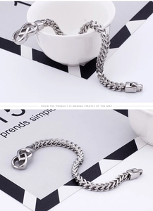 Detailed view of silver dragon bone chain bracelet with infinity symbol clasp
