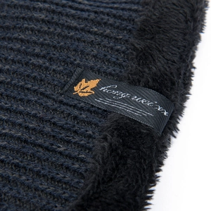 Winter knit hat with thick fleece lining and black brand label for cold weather protection