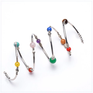Macro shot of colorful beads and silver spiral frame on multilayer chakra wrap bracelet