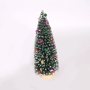 Mini green flocked Christmas tree with snow effect and colorful baubles on wooden base