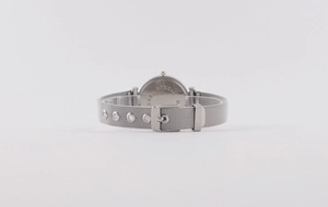 Detailed view of silver stainless steel mesh strap and secure buckle on a women watch