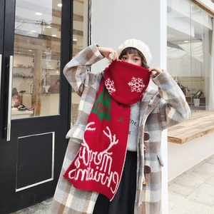 Winter red knitted Christmas scarf with Merry Christmas text and snowflake patterns