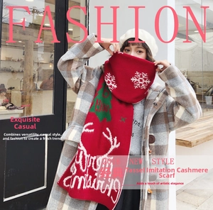 Detail of red Christmas knit scarf featuring white snowflake patterns and reindeer motifs