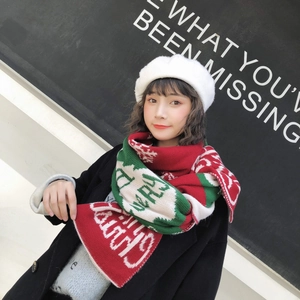Detail of Christmas knitted scarf with Merry Christmas text and snowflake patterns