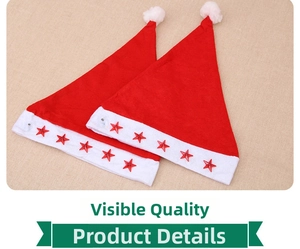 Close-up of two red velvet Christmas hats with white plush trim and sparkling red stars