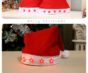 Detail view of glowing red Christmas hat with light-up stars in a cozy festive setting