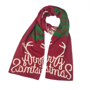 Winter red knitted Christmas scarf with green reindeer and Merry Christmas patterns