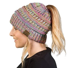 Side view of multi-color knit beanie featuring ponytail hole and C.C leather patch