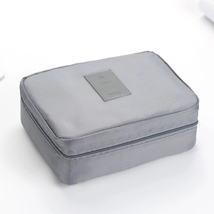 Grey large capacity travel toiletry bag with zipper closure and durable nylon texture