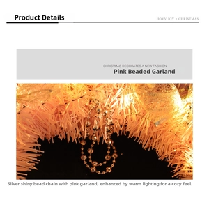Detail of pink Christmas garland with silver beads and warm LED decorative lighting