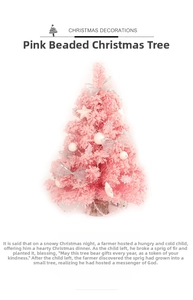 Close-up of a pink mini Christmas tree with silver bead chains and festive ornaments