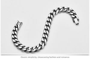 Detail of matte silver Cuban chain bracelet with heavy links and a folding clasp closure