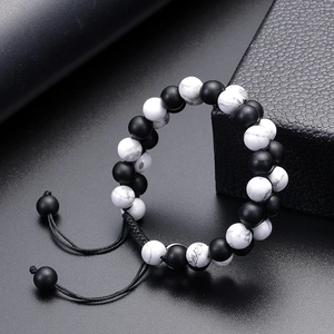 Macro view of double-layer matte black and white turquoise beads with adjustable cord detail