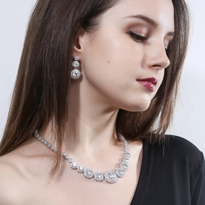 Elegant silver-toned bridal jewelry set with micro-paved zircons on a model