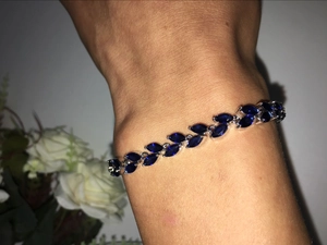 Detailed macro view of the silver bracelet with marquise-cut navy blue crystal stones