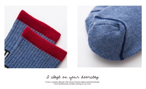 Detailed close-up of ribbed cuffs and reinforced toe stitching on blue cotton crew socks