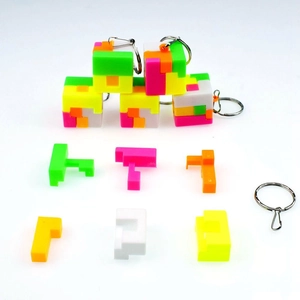 Macro view of disassembled colorful puzzle cube keychains showing plastic parts