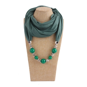 Ethnic style green beaded neck scarf necklace displayed on a professional beige mannequin