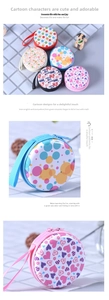 Detail of round cartoon coin purse with zipper closure and portable hanging strap