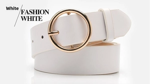 Detail of white belt with golden round buckle showing clean stitching and refined texture