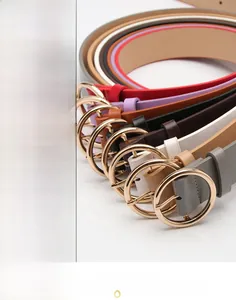 Multiple colorful PU leather belts with golden round metal buckles displayed on white surface