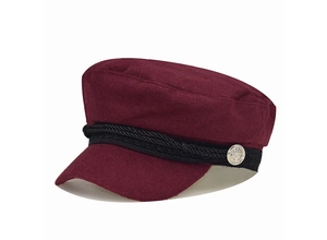 Close-up of wine red marine cap with black braided rope and silver anchor button detail