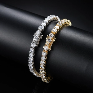 Detail of silver and gold tennis bracelets with round-cut cubic zirconia and secure clasp