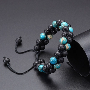 Detailed shot of double-row lava rock and turquoise beads with adjustable woven cord