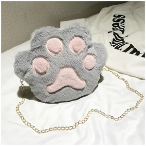 Detail of grey plush cat paw bag featuring pink soft pads and a golden metal chain