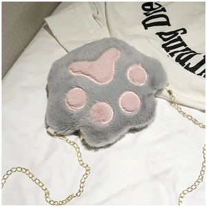 Detail of plush cat paw crossbody bag with soft faux fur and gold metal chain strap