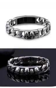 Macro shot of a silver skull relief cuban chain bracelet for men with punk style detail