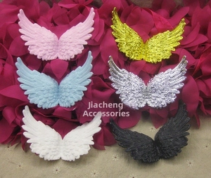 Detailed macro view of six pairs of colorful plastic angel wings for craft decoration