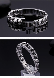 Detailed view of silver skull bracelet buckle and 316L stainless steel textured links