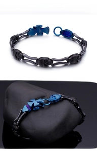 Detail of 316L stainless steel bracelet showing skull links and blue cross engraving