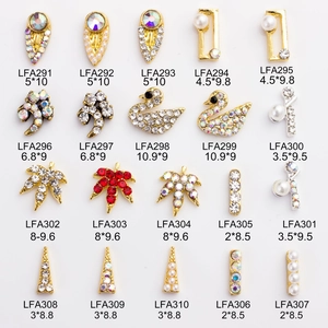 Detailed grid of 20 golden nail art charms featuring rhinestones and pearls