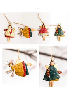 Detail of vintage iron Christmas angel ornaments with hammered texture and hemp rope