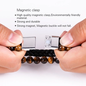 Detail showing the magnetic silver clasp and layered leather texture of the men's bracelet