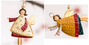 Detailed view of hand-painted metal angel ornaments with rustic festive textures