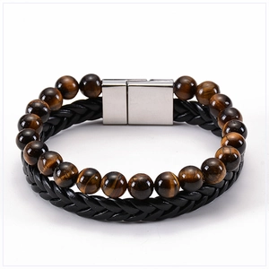 Close-up of tiger eye stone beads and black braided leather with magnetic clasp