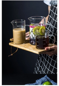 Three heat-resistant borosilicate glass measuring cups with handles and pouring spouts